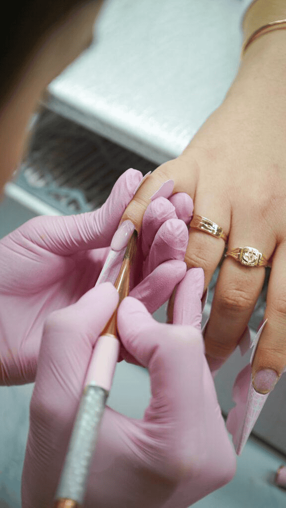 Manicure being done at My Onenail SPA with pink gloves and precision tools.